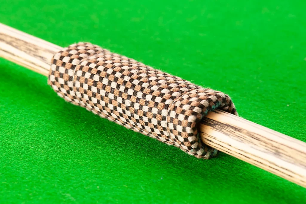 Britannia Cue Slicker being used to clean a snooker cue shaft